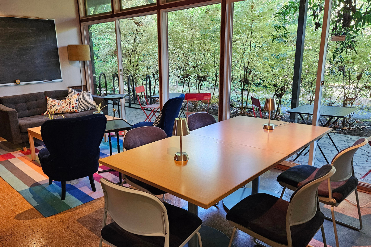 Table, chairs, couch and chalkboard in a room