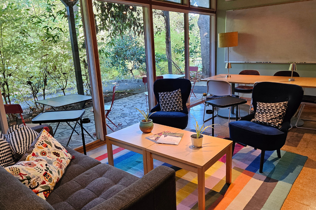 Couch, chairs, table and whiteboard in a room