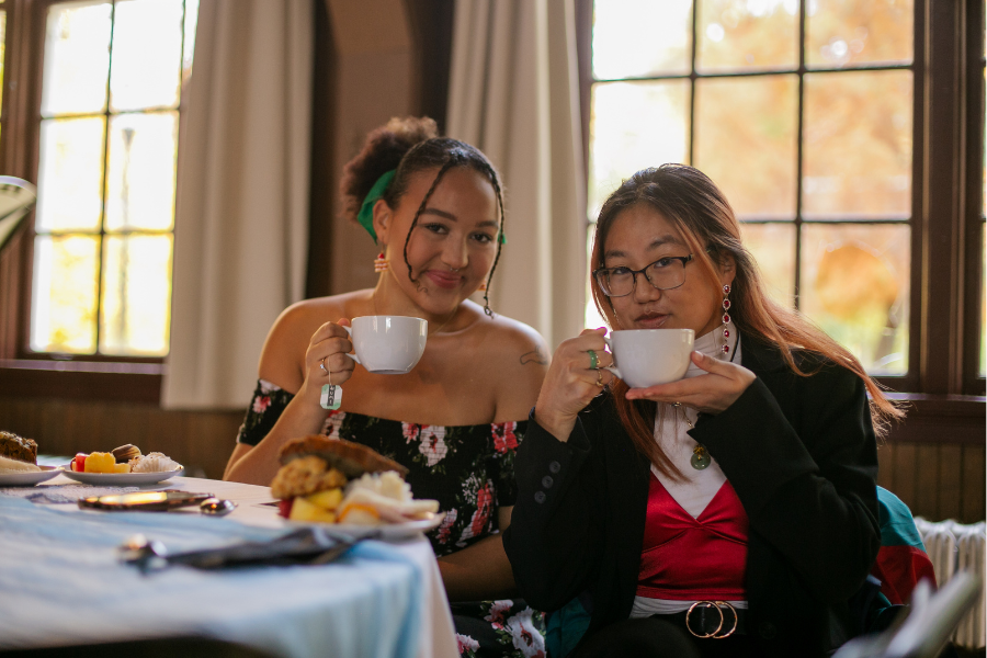 Two Reed students sipping tea at the Gray Fund Tea Party.