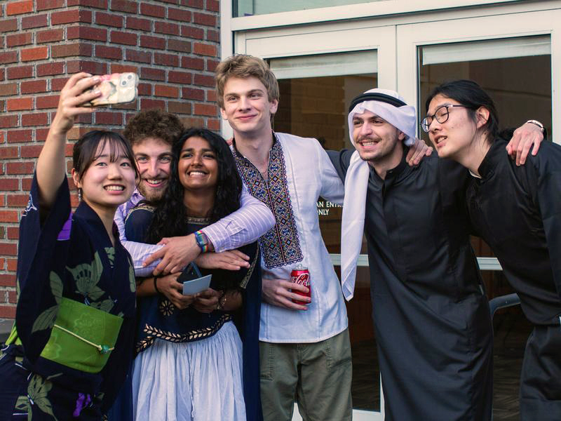 Six students pose for a selfie outside of the Gray Campus Center.