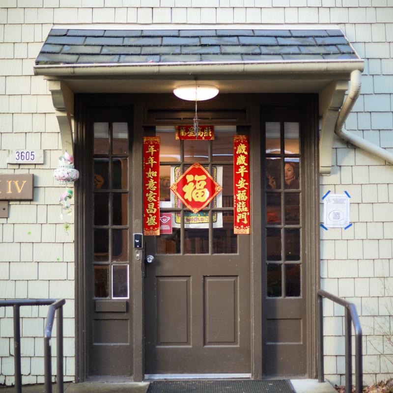 The door to the Chinese House, covered with red and gold Chinese characters