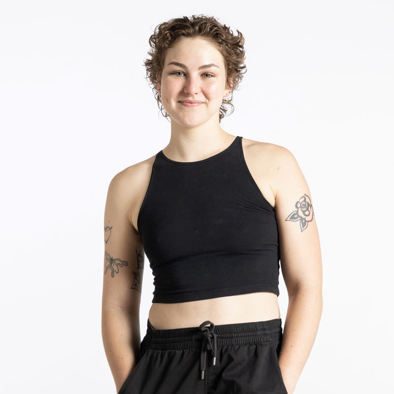 A portrait photo of Olivia McGough, who poses in a black tank top and black pants