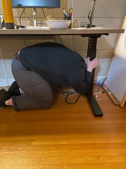Reed employee underneath desk