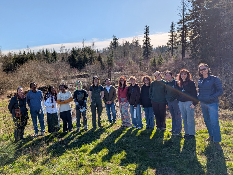 Group photo of faculty and students in the woods