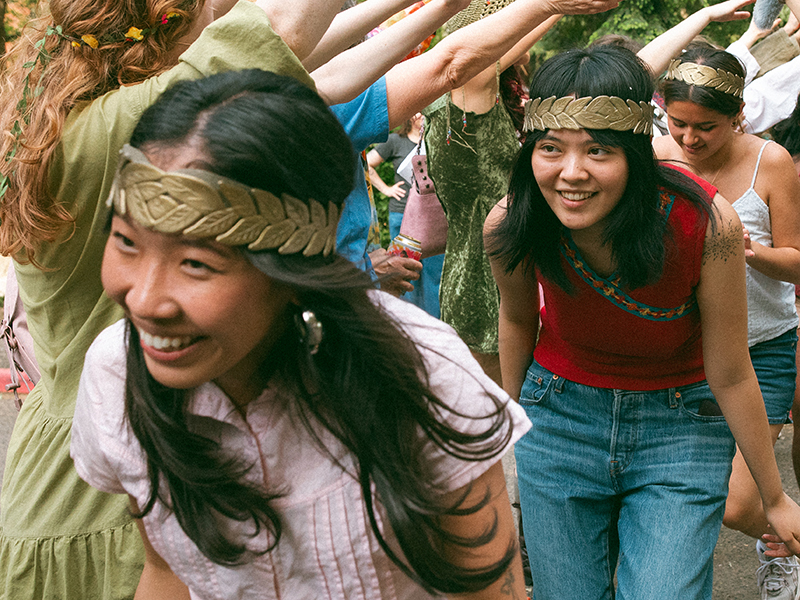 Students walk through a human tunnel during the thesis parade.