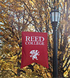 Reed campus banner with fall tree folliage in the background
