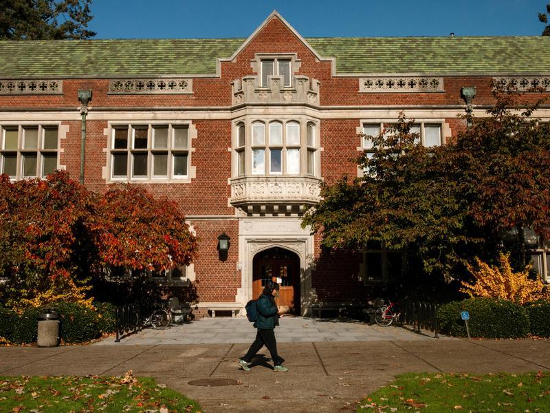 Two students wearing gold laurels and smiling outside.