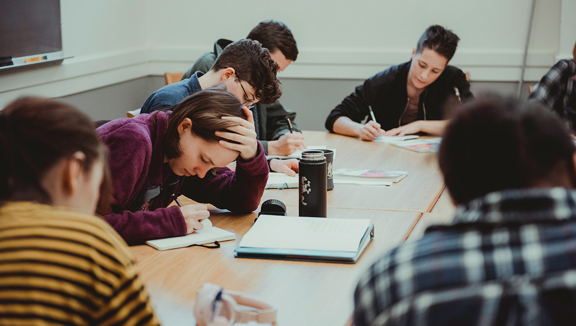 several students taking notes in class