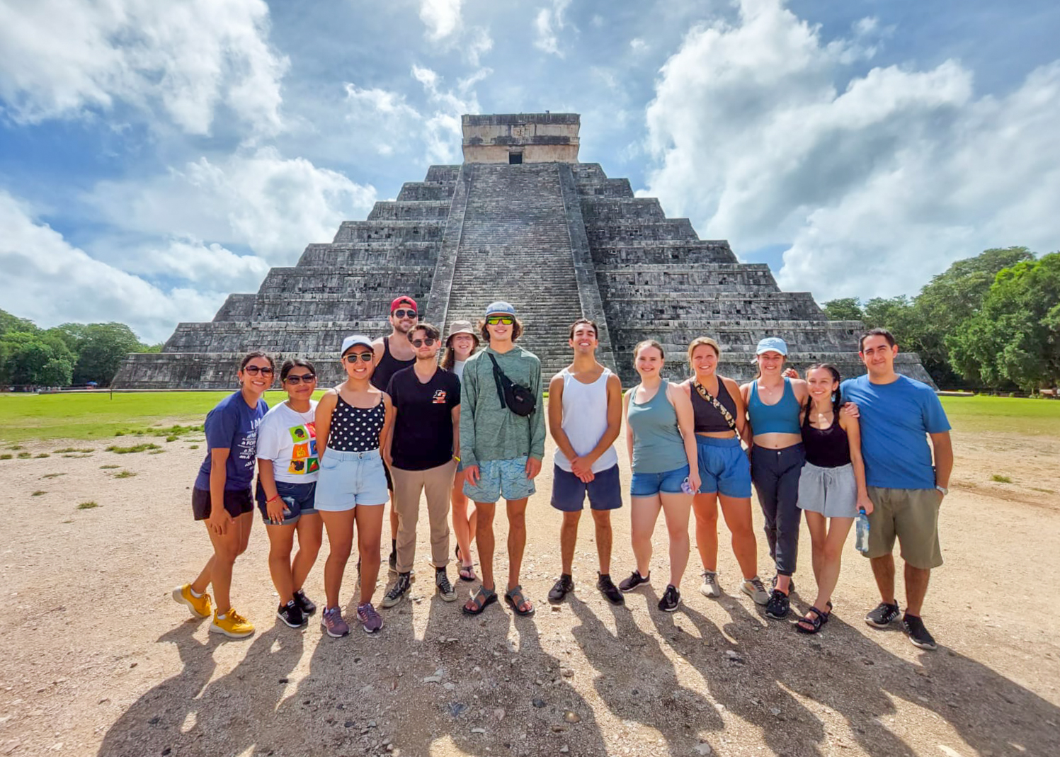 Students stand in front of a Mayan pyramid