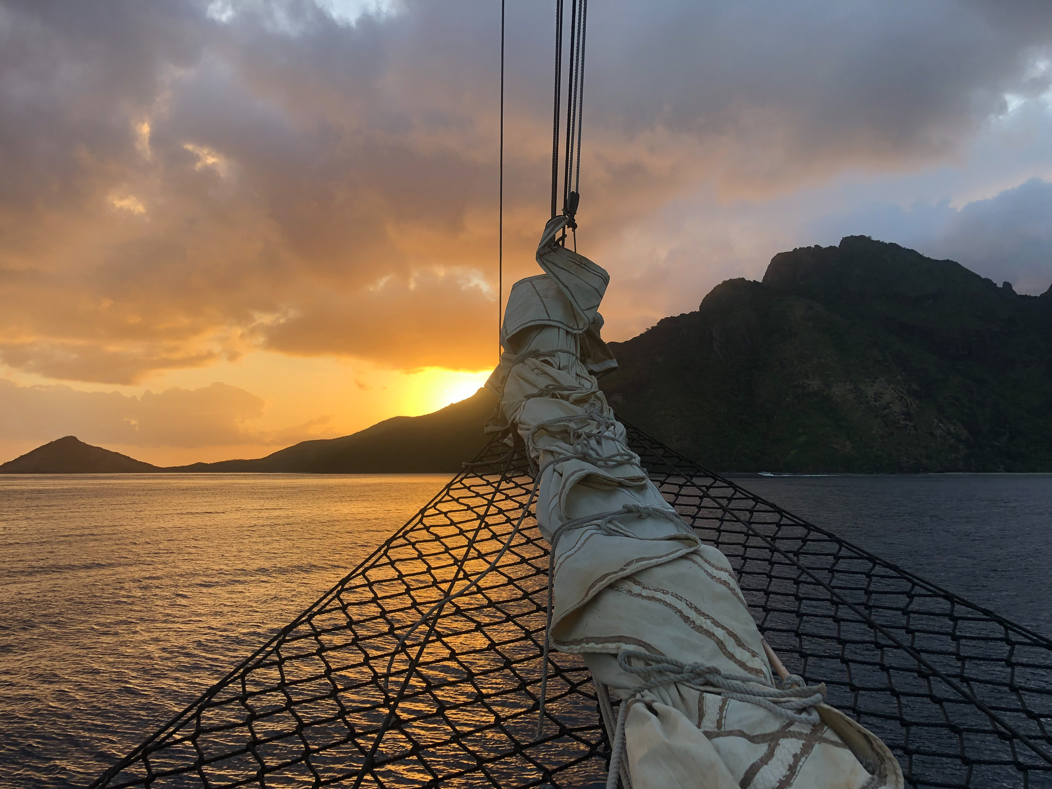 The bow of a sailing ship at sunset