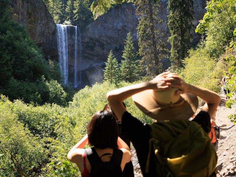 Students looking at a waterfall during a hike.