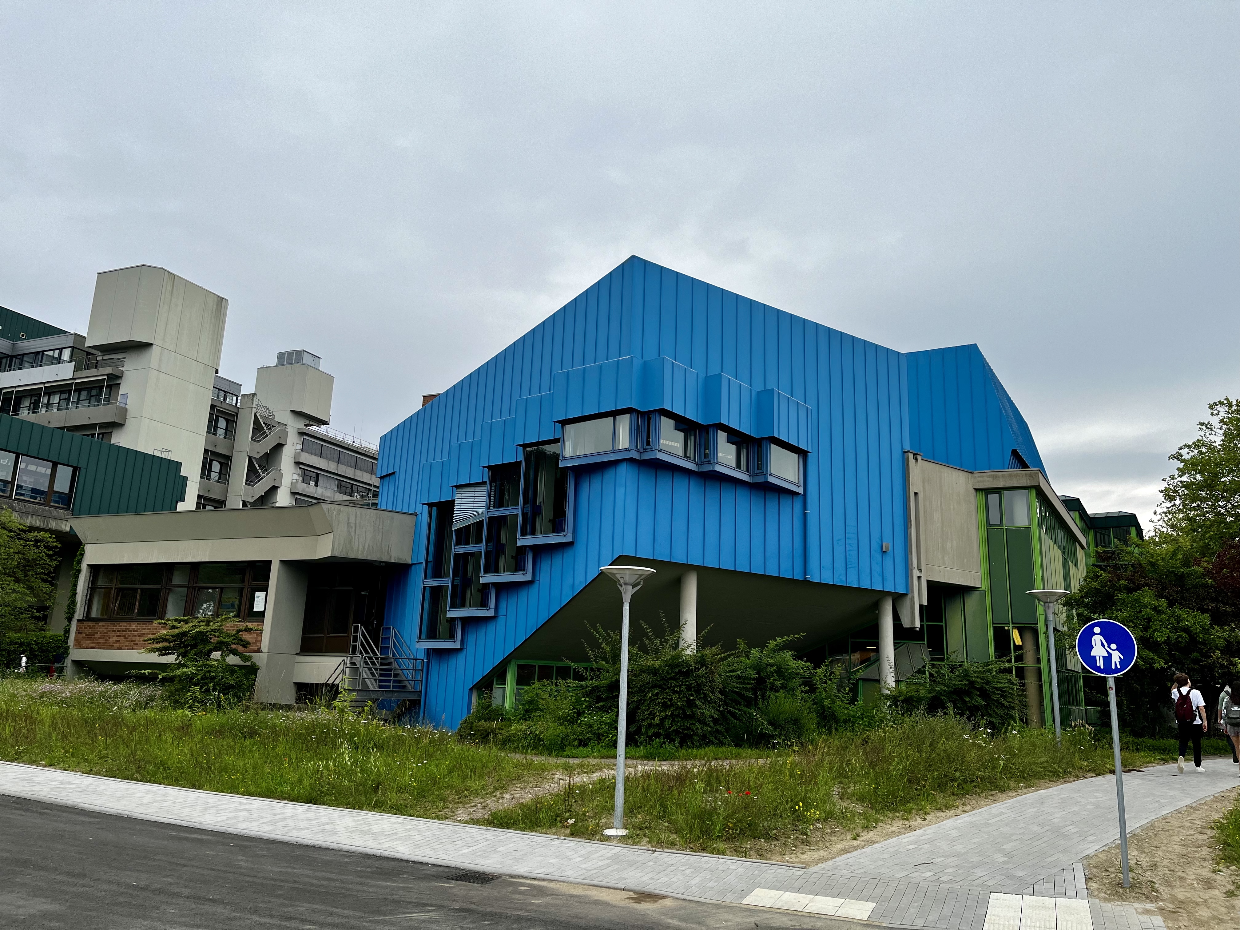 A blue square building on the university's campus