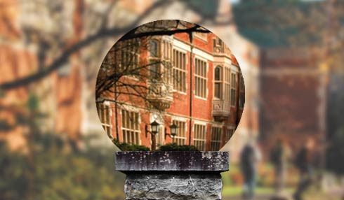 A photo illustration of mirror ball in front of Eliot Hall, which is blurry outside of the ball but sharp through the ball.