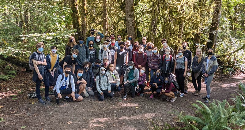 A large group of students posing for a photo during a hike