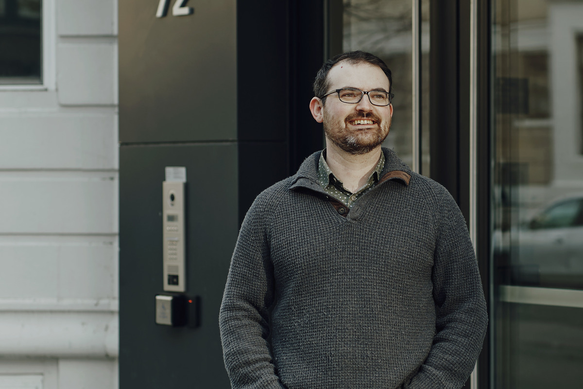 Nick Pittman standing outside a building and smiling.