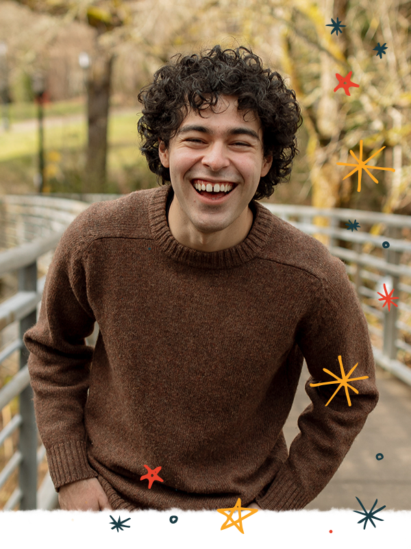 Derrick Santillan Valdez laughing while posing for a photo on the blue bridge.