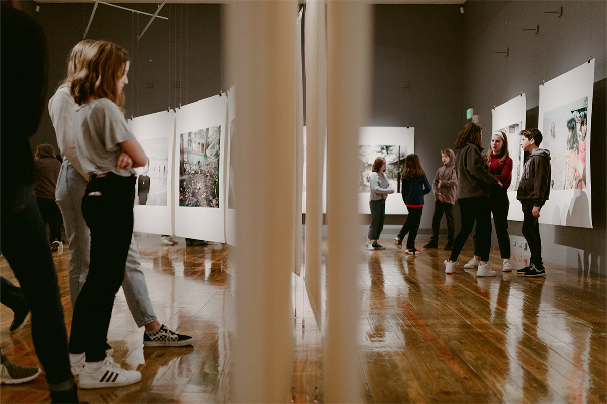 K–12 students looking at art in a gallery on the Reed campus. 