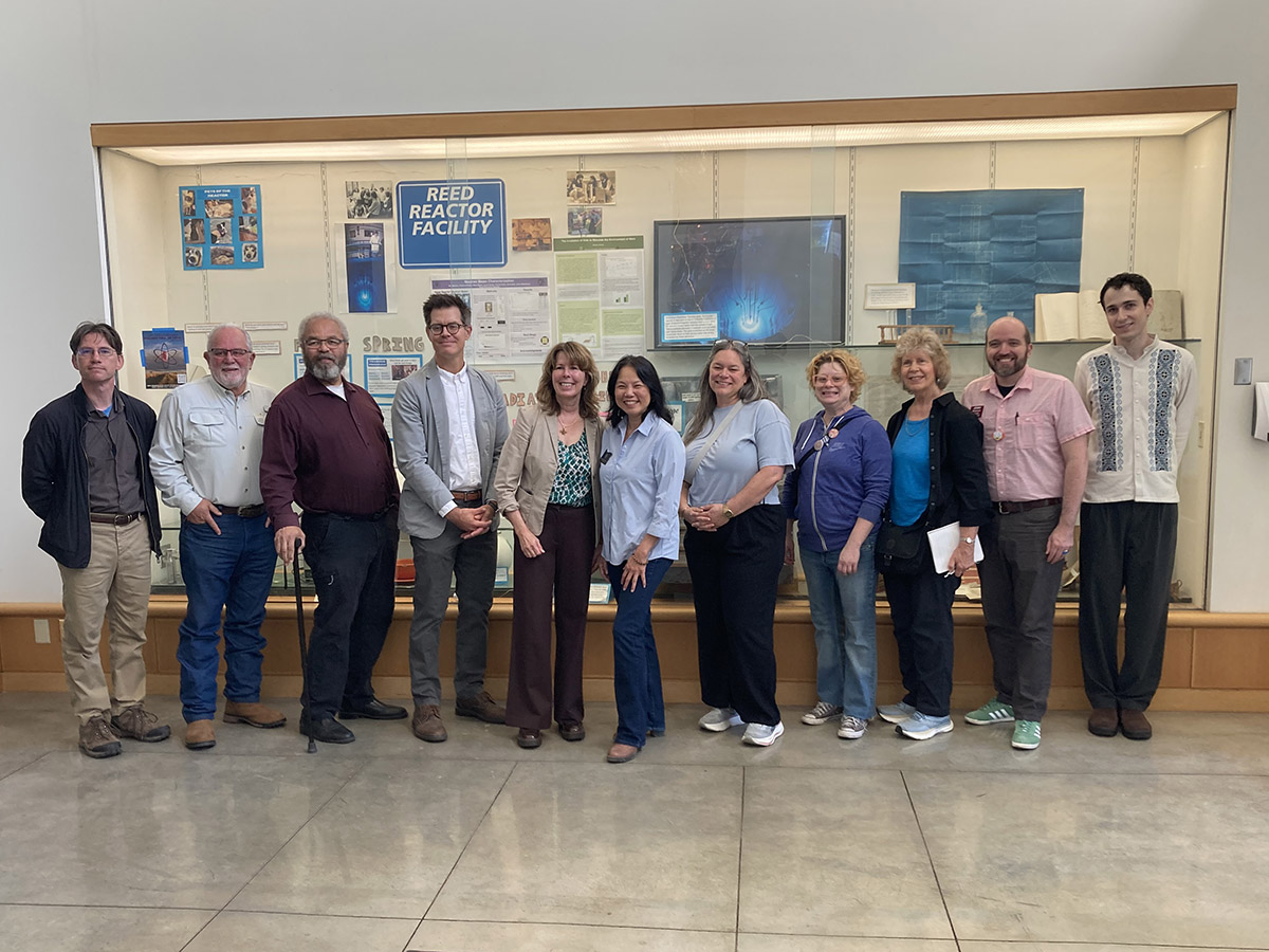 Audrey Bilger in chemistry building lobby with Oregon lawmakers.