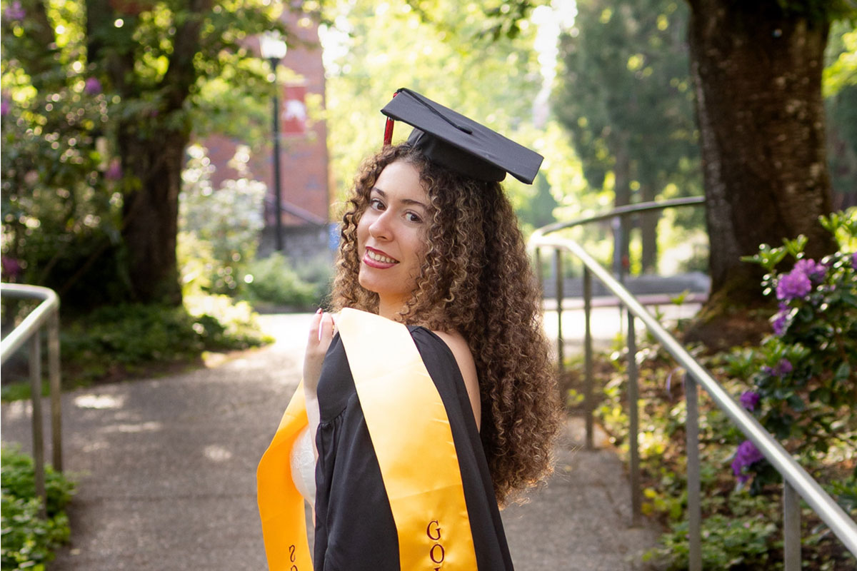 Luisa Morgan poses in graduation regalia on the Reed campus.