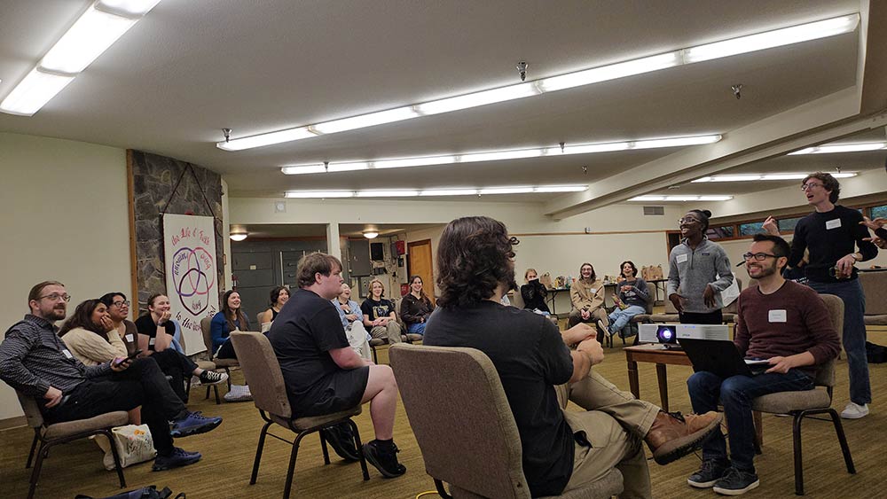 Multiple students seated in a large circle participating in a psychology game