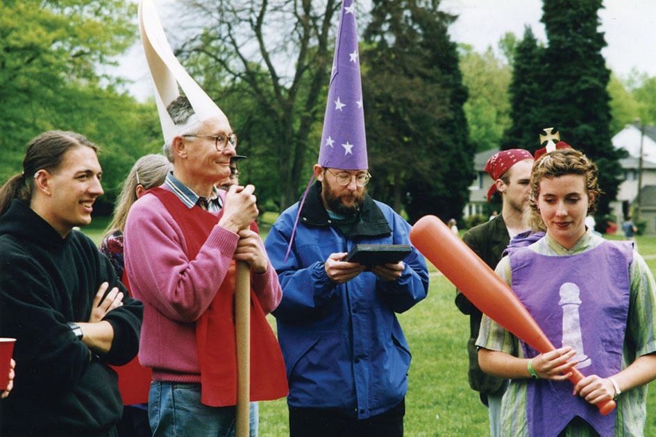 STATISTICIAN on A MISSION: Prof. Jones (purple wizard hat) ponders probabilities as he directs human chess game at Renn Fayre in 1997. On the left, Prof. Bill Peck [philosophy 1961&amp;#8211;2002] clutches curtain-rod of doom.