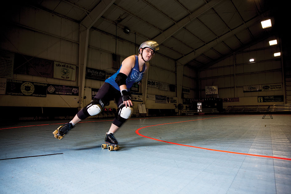 Jenna Routenberg &amp;#8217;18 as her roller derby alter ego, Sui Jennaris, skates in the Hangar at Oaks Park.