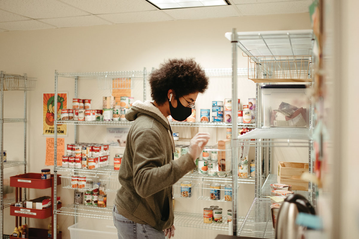 The gift from Kathy and Alex Martinez &amp;#8217;73 will help students pursue social justice in many forms. Here Anthony Hill &amp;#8217;22 works on restocking the shelves in the Reed Community Pantry.