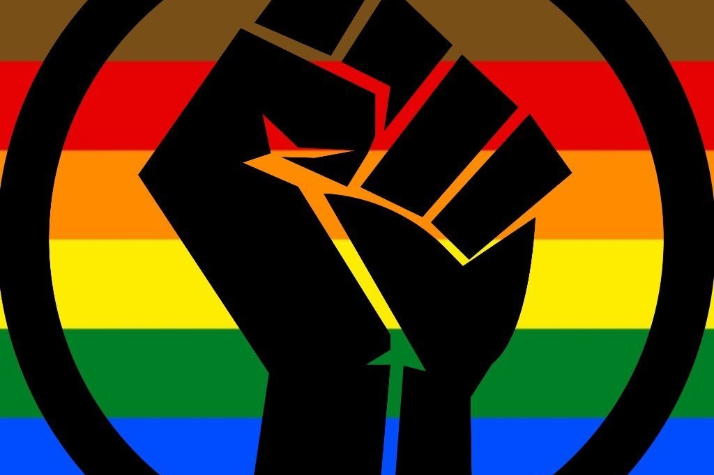 Black Lives Matter fist with pride flag in the background