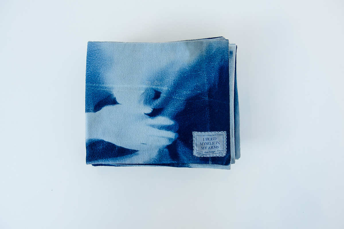 Soft cloth book with blue and shadow of hand in white