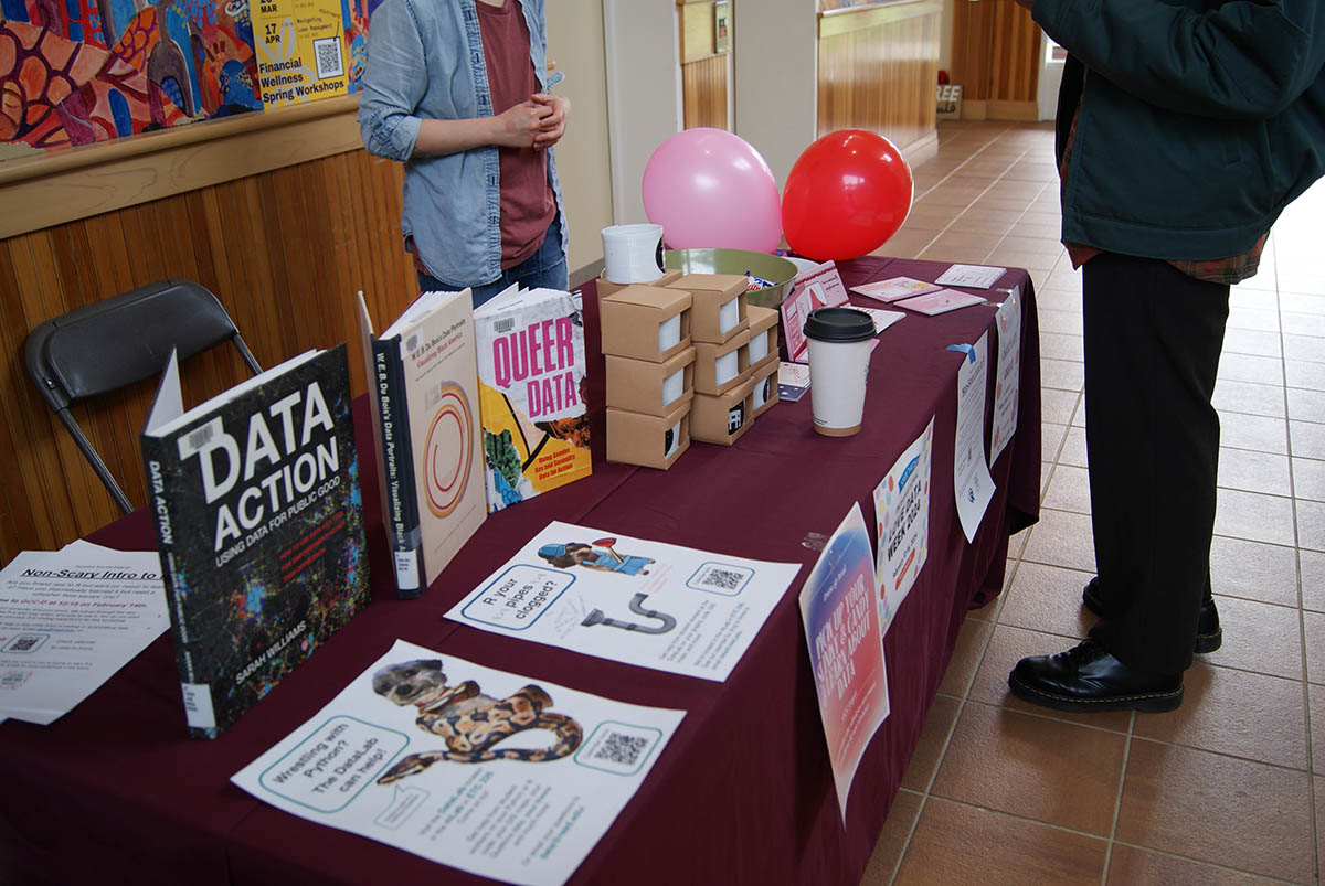 A collection of books about data displayed on a table with a maroon tablecloth