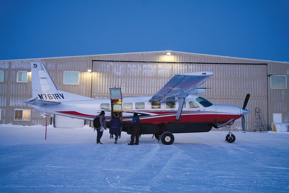 Lana loads passengers onto a Cessna Caravan for a scheduled flight from Deadhorse (Prudhoe Bay) to Utqiagvik via the native village of Nuiqsut.
