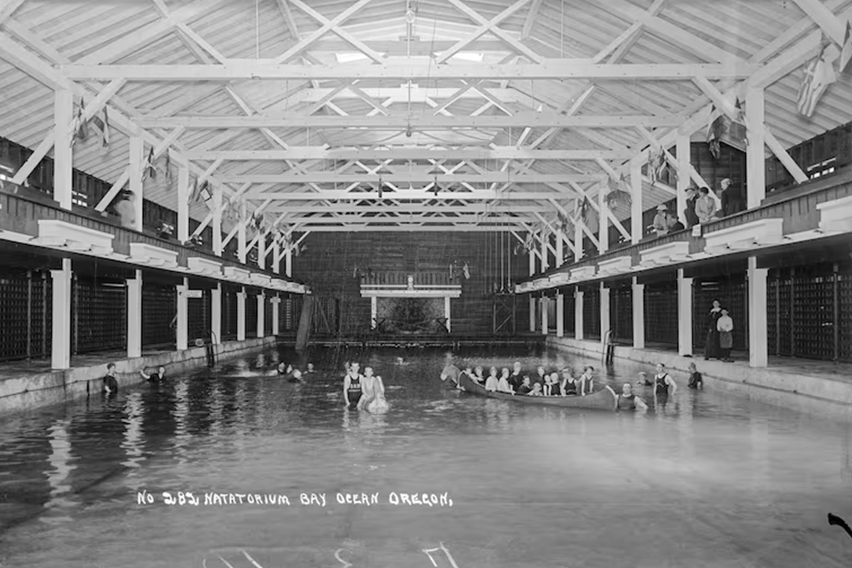 People pose in the natatorium of the Bayocean resort in a black and white archival photo. 
