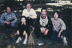 Jan (background, arms crossed) with kleng master Bua Xou Mua (wearing ceremonial necklace) and his son Lee (far right) at the CityFolk festival in 1981. Also pictured are Bua’s young kleng student and his father.