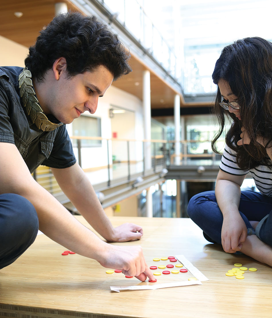 Florin Feier ’17 contemplates his strategy against Alicia Toshima ’17 in a game of Disconnect Three.