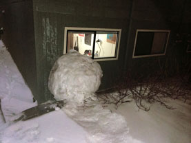 Reed College students, both math majors, roll giant snowball.