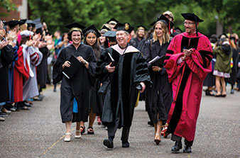 HERE’S LOOKING AT YOU, KID. Prof. Virginia Hancock ’62 [music] leads the procession at Commencement ’16, her last before retirement.