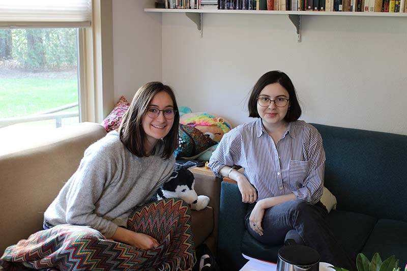 Two students site in the living room of the Russian House
