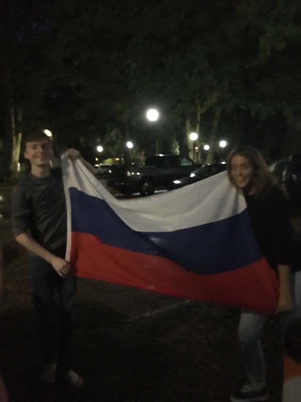 Two students holding the Russian flag