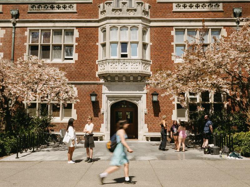 Students walking and mingling outside of Eliot Hall.