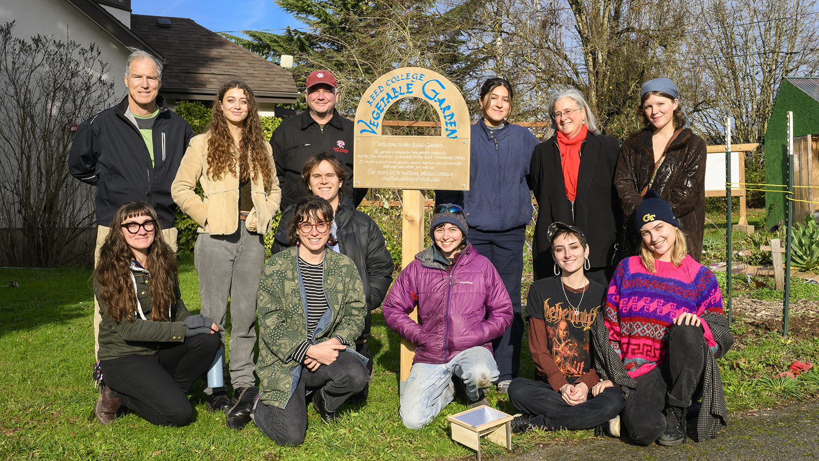 Group photo of class with the garden sign