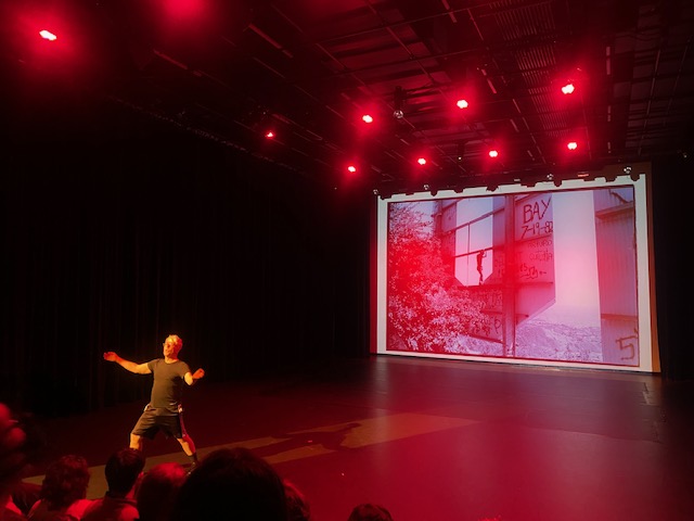 Tim Miller performs in front of screen